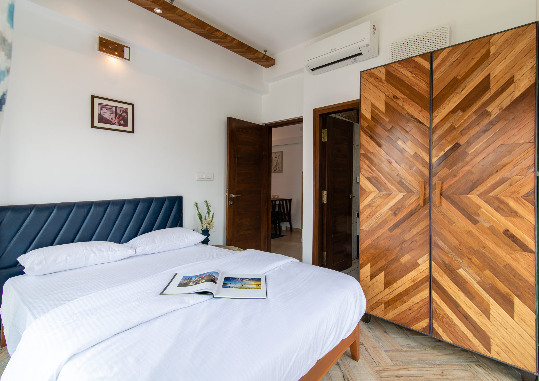 The Aspen Bedroom' wood themed interiors in the Wood Apartment at the Jazminn, luxury service apartments in Kalyan Nagar